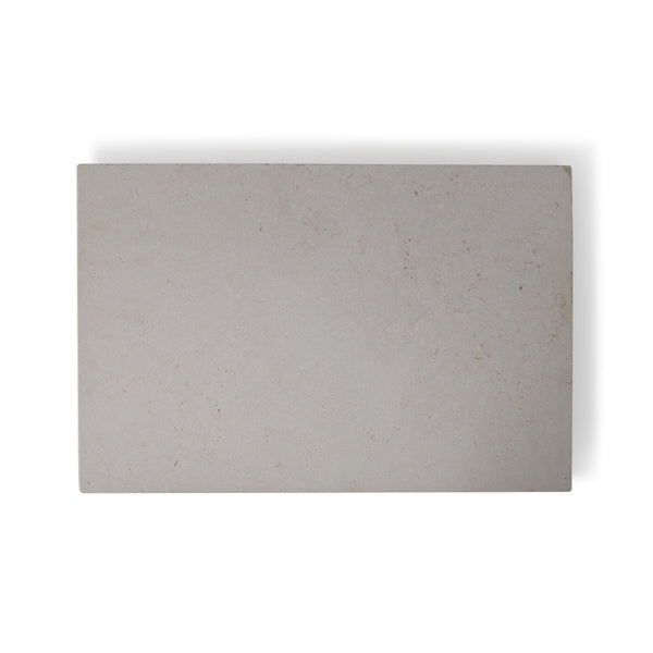 A close-up image of Sandblasted Tunisian Pearl Limestone tiles showing the pale creamy white color with natural fossils and veining.