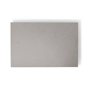 A close-up image of Sandblasted Tunisian Pearl Limestone tiles showing the pale creamy white color with natural fossils and veining.